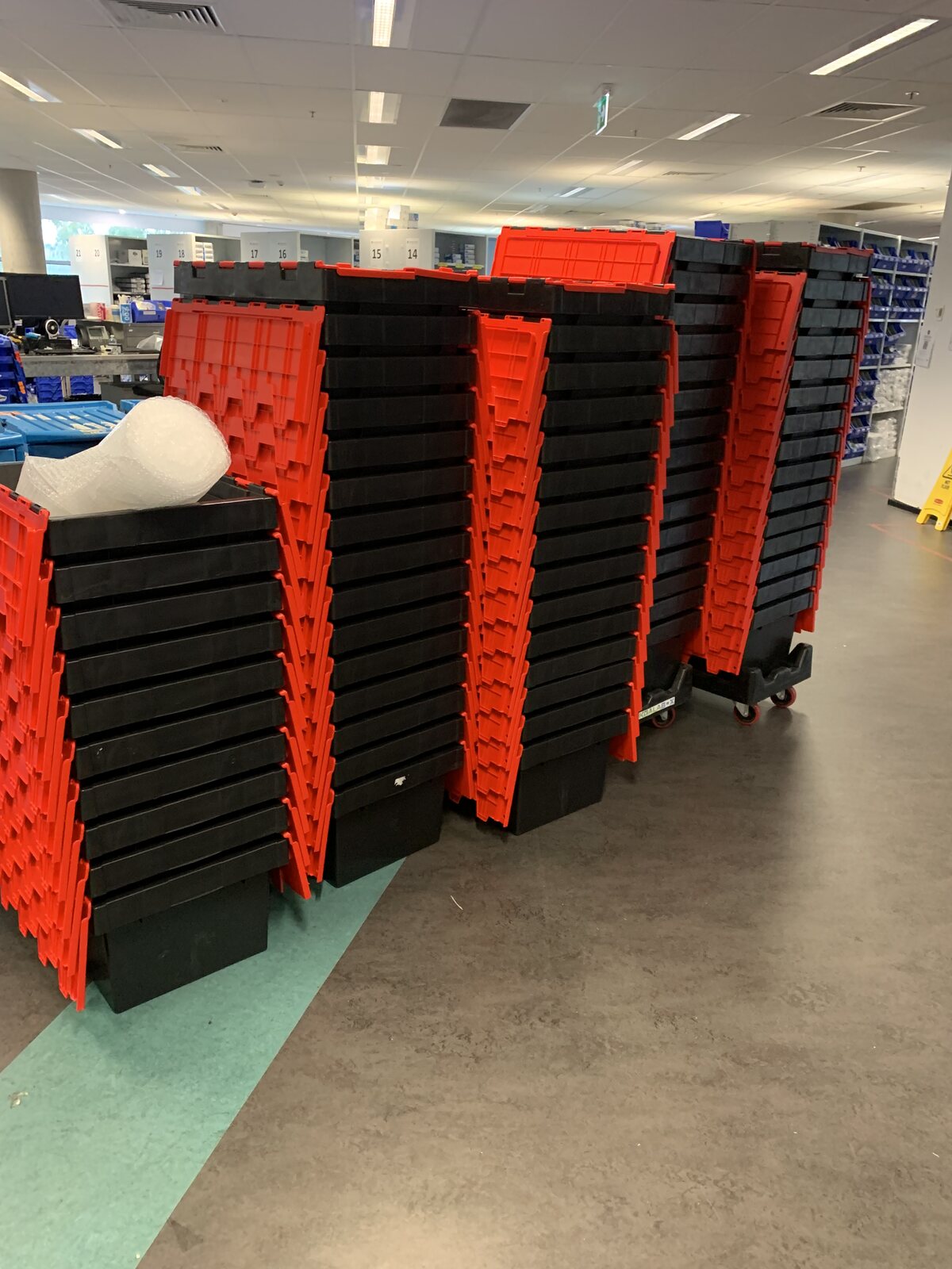 30 durable plastic moving crates stacked for a Sydney move